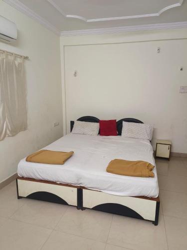 1 dormitorio con 1 cama grande con sábanas blancas en Flagship La Grande Residencya en Old Goa