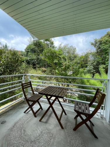 a picnic table and two chairs on a porch at Lin Qi in my heart Villa in Dongshi