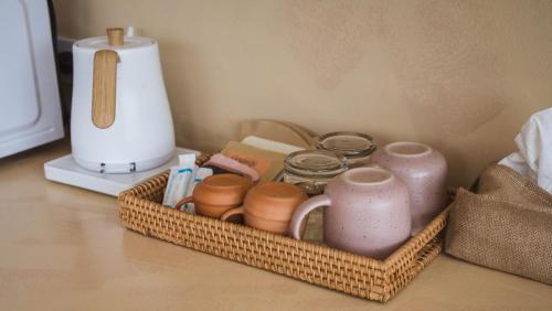 a basket filled with pots and jars on a counter at Casa Solana in Patong Beach