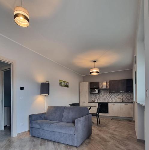 a living room with a couch and a kitchen at Via Casne 2 Volpiano (TO) in Volpiano