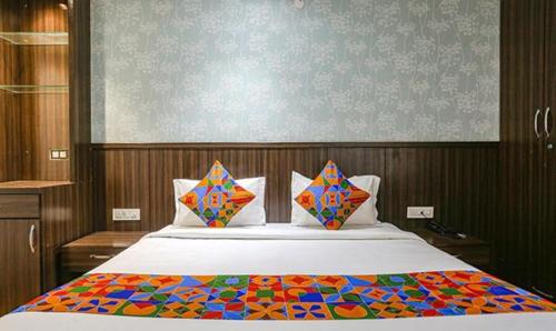 a bedroom with a large bed with a colorful comforter at FabExpress RG Stay in New Delhi