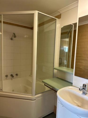 a bathroom with a bath tub and a sink at The Shamrock Hotel in Toowoomba
