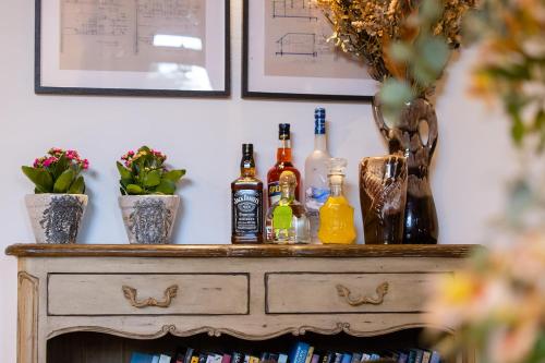 a table with bottles of alcohol on top of it at THE HOUSE ROSH PINA - 2BRM WITH POOl in Rosh Pinna