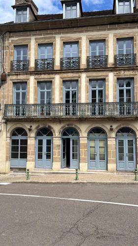 a building with windows and balconies on the side of it at Appartement Le palais autun in Autun