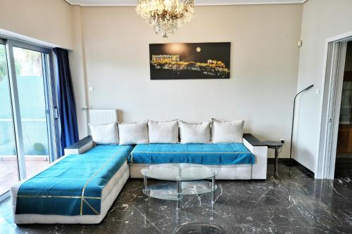 a living room with a couch and a table at Piraeus yacht view apartment in Piraeus