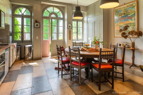 Saint-Paterne-RacanにあるGîte des Ecuries d'Hodebertのキッチン(ダイニングルームテーブル、椅子付)