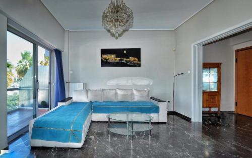 a bedroom with a blue bed and a glass table at Piraeus yacht view apartment in Piraeus