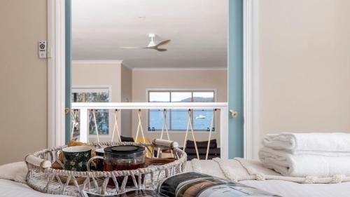 a living room with a coffee table and a view of the ocean at Zahirs Retreat in North Arm Cove