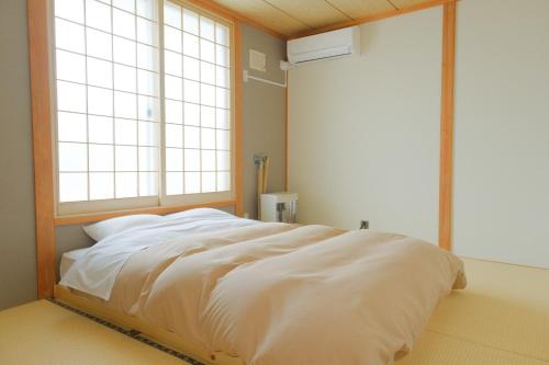 En eller flere senge i et værelse på North Maison Biei Omachi - Vacation STAY 14843
