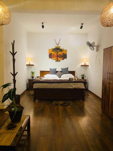 a bedroom with a large bed in a room at The kingdom of ella in Ella