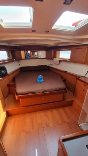 a small bed in the back of a boat at Pirate & Captain's Sailboat in Kampong Lalang