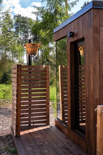 a wooden building with a door and a bird feeder at Villa Isabell in Kõrve Üks