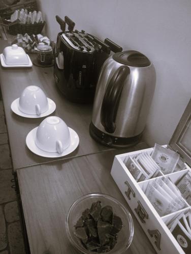 a counter top with a coffee pot and plates at Hotel Pace in Pompei