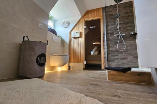 a bedroom with a bathroom with a shower and a tub at Ferienwohnung De ole School mit eigener Sauna! in Fehmarn