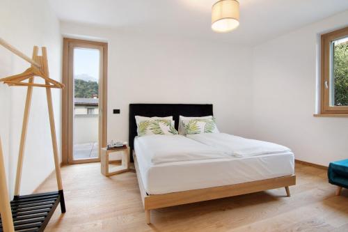 a bedroom with a bed and a large window at La Villa del lago in Colico