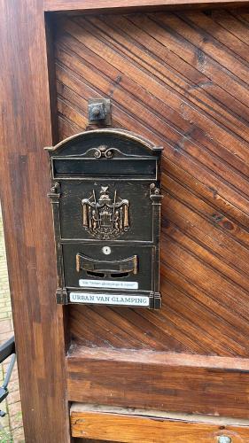 an old stove sitting on top of a wooden wall at Urban Van Glamping Riga in Rīga