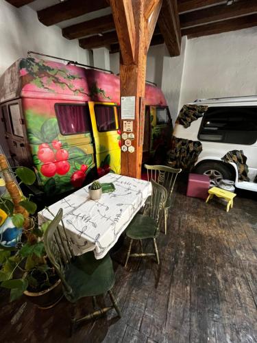 a dining room with a table and a caravan at Urban Van Glamping Riga in Rīga