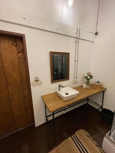 a bathroom with a sink and a mirror on the wall at Urban Van Glamping Riga in Rīga