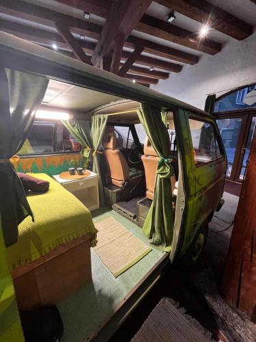 a van with its door open in a room at Urban Van Glamping Riga in Rīga