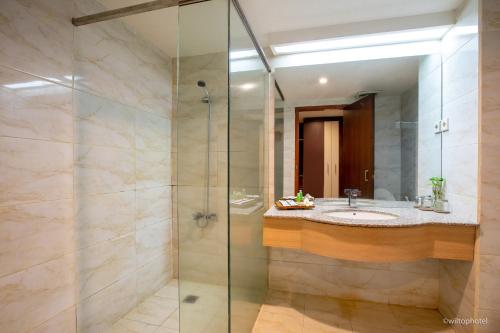 a bathroom with a sink and a glass shower at Wiltop by BENCOOLEN in Jambi