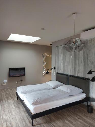 a bedroom with a large bed and a painting on the wall at SEA YOU in Klink