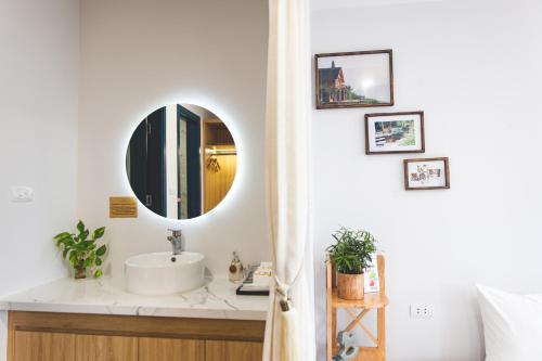 a bathroom with a sink and a mirror at Interconnection Ba Vì Venuestay in Hanoi