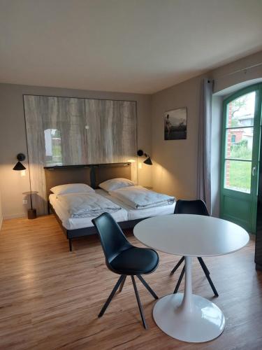 a bedroom with a bed and a table and chairs at SEA YOU in Klink