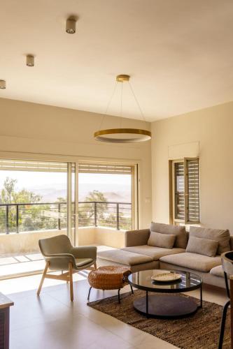 a living room with a couch and a table at סיני 48 מלון דירות בוטיק in Vered Yeriho