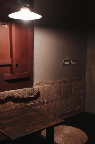 a dining room with a wooden table and a light at 序室 Narrative in Jinhu