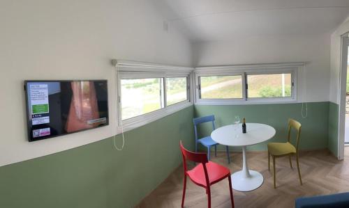 a room with a table and chairs and a tv at Villa San Biagio Residence in Mason Vicentino