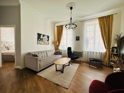 a living room with a couch and a table at Very Vilnius Stikliu street in Vilnius