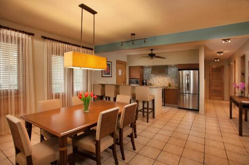 a dining room and kitchen with a table and chairs at Copamarina Beach Resort & Spa in Guanica