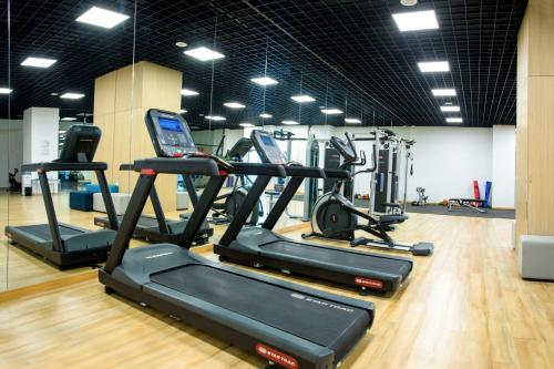 a gym with several treadmills and elliptical machines at Holiday Inn Express Xiamen Airport Zone by IHG in Xiamen