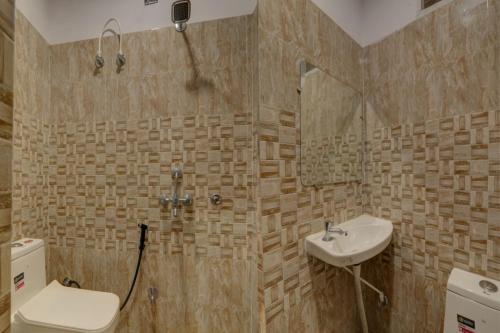 a bathroom with a toilet and a sink and a shower at Hotel Madhav Inn Top Family Hotels Business Hotels Best Couple Friendly Hotel in Lucknow in Lucknow