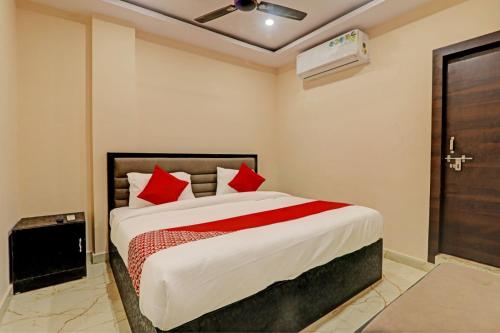 a bedroom with a large bed with red pillows at Hotel Madhav Inn Top Family Hotels Business Hotels Best Couple Friendly Hotel in Lucknow in Lucknow