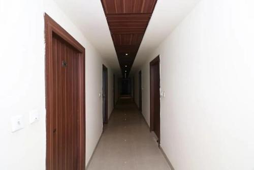 an empty hallway with two doors and a hallway with a corridorngthngthngthngth at Hotel Madhav Inn Top Family Hotels Business Hotels Best Couple Friendly Hotel in Lucknow in Lucknow