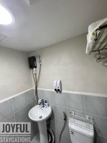 a bathroom with a sink and a toilet at Condo with resort-like living, everyday in Lapu Lapu City