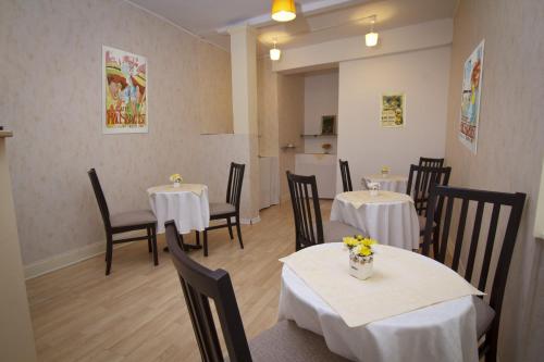 a restaurant with two tables and chairs with flowers on them at Bed & Breakfast Vila Baguc in Split