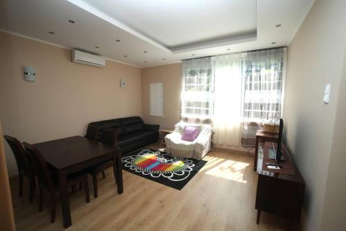 a living room with a table and a couch at Charming House - Santarém in Santarém