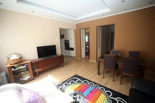 a living room with a bed and a dining room at Charming House - Santarém in Santarém