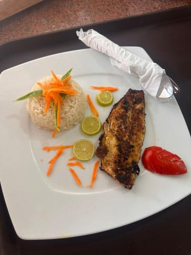 a plate of food with rice and meat and carrots at Panorama Lodge Nuweiba in Nuweiba