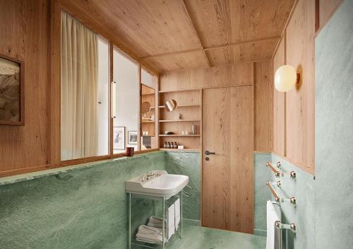 a bathroom with a sink and a mirror at Grand Hôtel Belvédère, Wengen, a Beaumier Hotel in Wengen