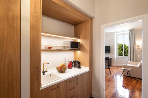 a kitchen with a sink and a microwave at Liston Bliss Suite in Corfu Town