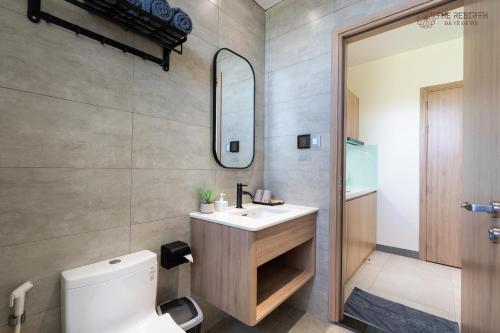 a bathroom with a white toilet and a sink at The Rebirth Apartment Binh Chau Ho Tram in Ba Ria
