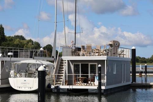 a small boat is docked at a dock at Hausboot Liliput in Stralsund