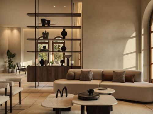 a living room with a couch and tables at Lindian Village All Inclusive Resort Rhodes,Curio Collection in Kiotari