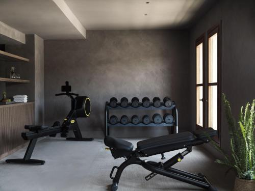 a room with a gym with a bench and a plant at Lindian Village All Inclusive Resort Rhodes,Curio Collection in Kiotari