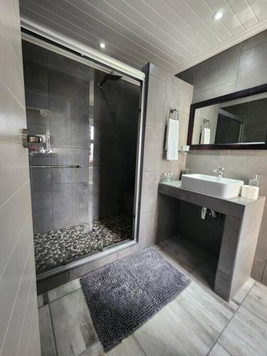 a bathroom with a shower and a sink at Hook Wine And Sinker in Langebaan