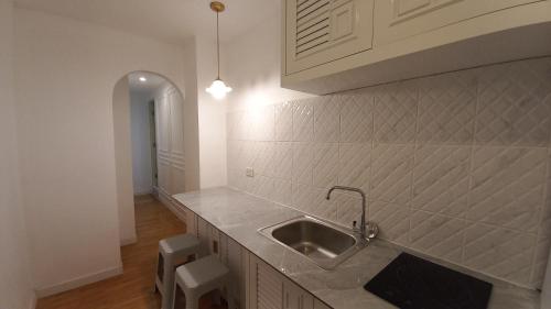 a kitchen with a sink and a counter top at Panoramic City View Room at Silom in Bangkok