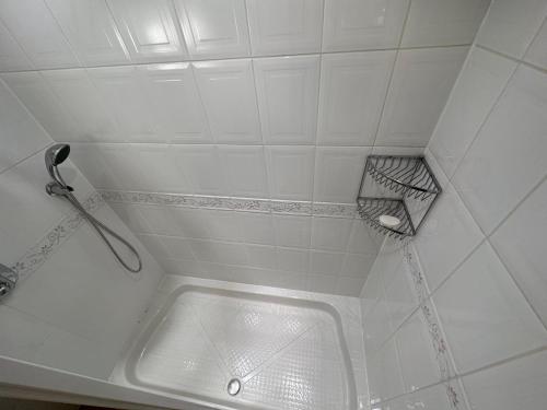 a white bathroom with a sink and a shelf at One Dunbar Court Gleneagles Village in Auchterarder